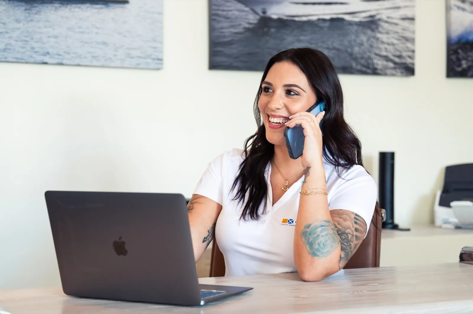 A YMS client coordinator on the phone at her laptop in the Fort Lauderdale office