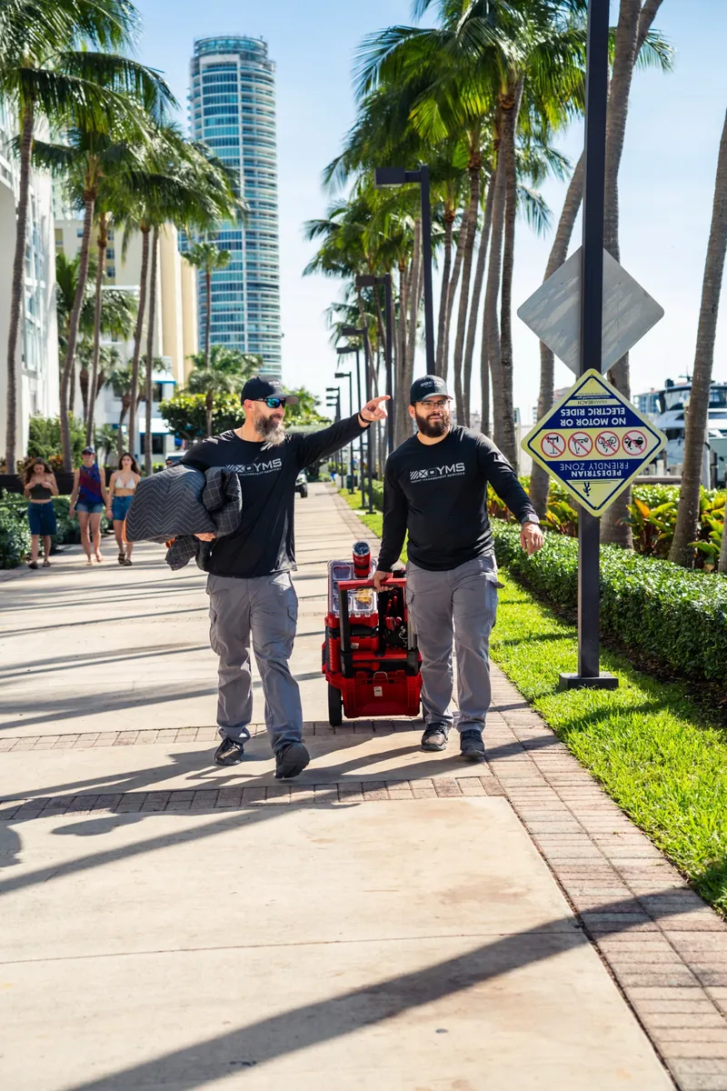 YMS crew moving equipment along a Miami waterfront